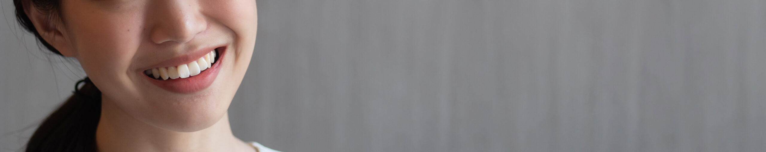 Woman with crooked teeth, concept image for mouth care, dental care, malocclusion or bad bites, minor teeth misalignment, overlapping tooth, uneven tooth of young adult woman